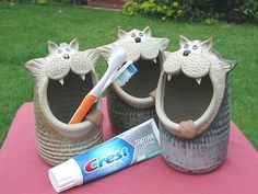 toothbrush and toothpaste on display in clay pots