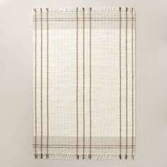 a white and brown checkered blanket hanging on a wall