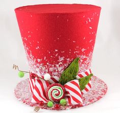 a red top hat decorated with candy canes and candies