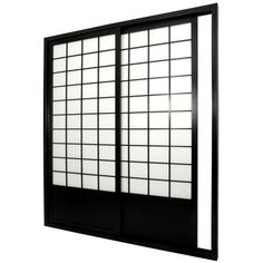 a black and white window with squares on the glass, against a white wall background