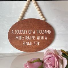 a wooden sign that says a journey of a thousand miles begins with a single step