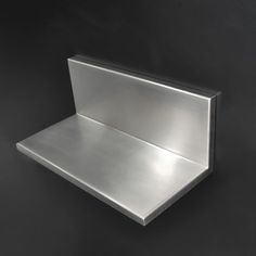 an empty metal shelf against a black background