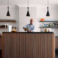 a man standing behind a counter in a restaurant