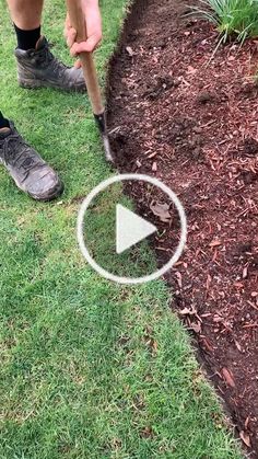 a man is digging in the grass with a shovel