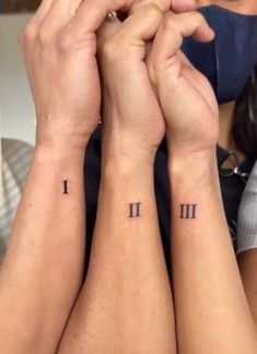 two people with matching tattoos on their arms