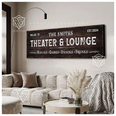 a living room filled with furniture and a large wooden sign on the wall above it