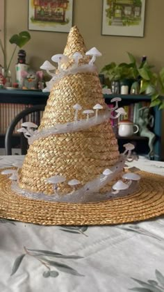 a straw hat with birds on it sitting on a table