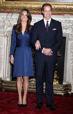 the royal couple are posing for pictures in front of an ornate fireplace with their engagement ring