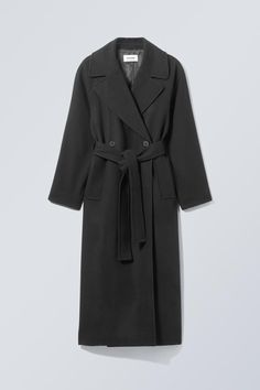 An oversized double-breasted coat for the colder months crafted from a soft felted wool blend twill. This go-to is lined with recycled polyester, has two large lapels, two front buttons, and a belt to cinch for a slouchy structured look.