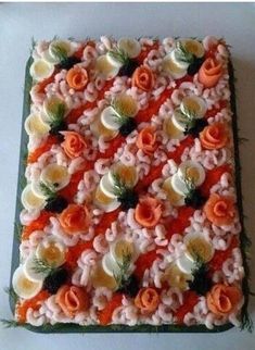 an orange and white cake with flowers on it