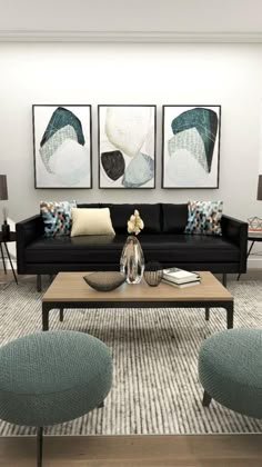 a living room with black couches and blue ottomans on the floor in front of two paintings