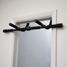 a mirror and some black handles on a wall