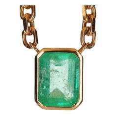 A spectacular unisex emerald solitaire necklace. The featured stone is 7.61-carats, emerald cut. The emerald has a beautiful medium green color, with very good luster and minor imperfections. This large beauty is set in a bezel-set, 14K yellow gold setting. The chain is solid gold and is 22.5 inches total with two stoppers so the necklace can be worn at shorter lengths. Setting Style: Bezel - Solitaire Setting Material: 14K Yellow Gold Weight: 61 Grams Main Stone: Colombian Emerald Shape: Emeral Solitaire Necklace, Solitaire Setting, Colombian Emeralds, Solitaire Necklaces, Yellow Gold Setting, Bezel Setting, Emerald Cut, Green Color, Green Colors