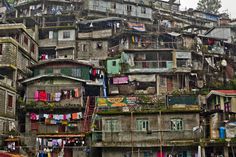 a large group of buildings with clothes hanging out to dry on the balconys and balconies