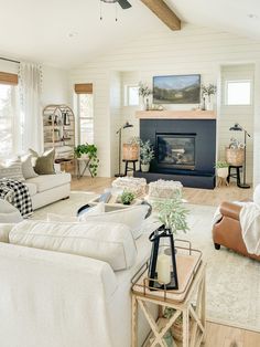 a living room filled with furniture and a fire place in the middle of a room