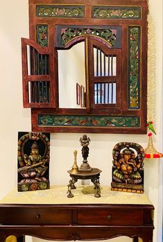 an ornate wooden table and mirror in a room