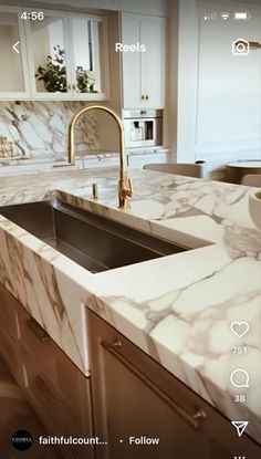 a kitchen with marble counter tops and an appliance on the phone showing what's in the sink