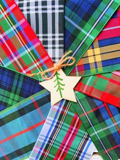 several different colored plaid fabric with a wooden star ornament on the top one