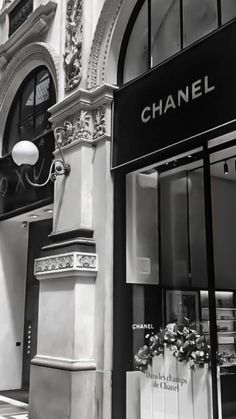 a chanel storefront on the corner of a street in front of a building