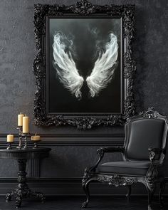 an ornate chair and table in front of a black wall with white angel wings on it