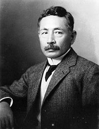 an old black and white photo of a man in a suit with a moustache