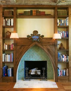 the fireplace is surrounded by bookshelves and shelves