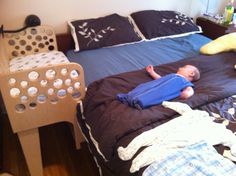 a small child laying on top of a bed