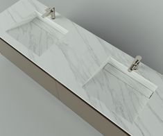 a white marble counter top with two sinks