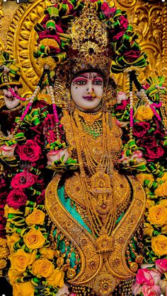 an elaborately decorated statue with flowers on it