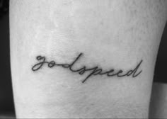 a small tattoo with the word god speed written in cursive writing on it