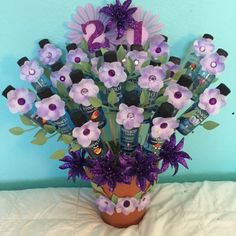 a vase filled with lots of purple flowers