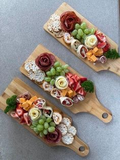 two wooden paddles with different types of food on them