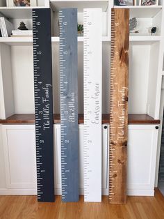 two tall rulers are next to each other in front of bookshelves and shelves