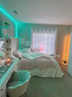 a bedroom with a bed, desk and chair in it's center area is lit up by blue lights