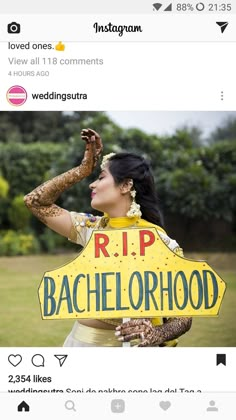 a woman holding up a sign that says r i p bachelorhood in front of her face