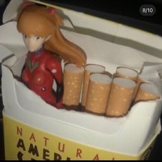 a box that has some cups in it and a figurine sitting on top