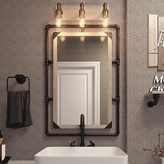 a white sink sitting under a bathroom mirror next to a wall mounted faucet