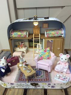 a doll house with furniture and accessories in the shape of a suitcase on a table