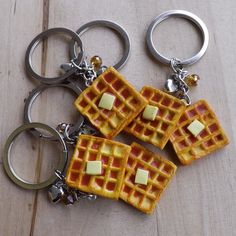 three waffles with butter on them sitting on a wooden table next to each other