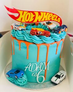 a birthday cake decorated with hot wheels and cars