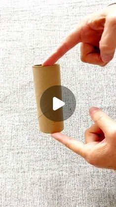 a person pointing at a roll of toilet paper