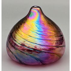 a colorful glass vase sitting on top of a table