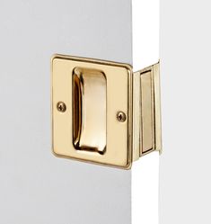 a close up of a door handle on a white door with gold handles and knobs