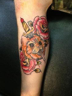 a person with a cat tattoo on their leg