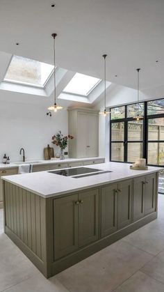 a large kitchen with an island and skylights