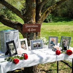 a table topped with pictures and flowers next to a sign that says generations of love