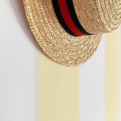 a straw hat is hanging on the wall