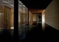 an empty hallway with wooden slats on the walls