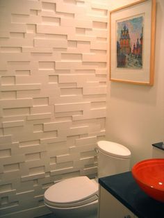 a white toilet sitting next to a red bowl on top of a sink in a bathroom