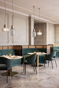 the interior of a restaurant with green velvet booths and gold accents on the walls, along with marble flooring